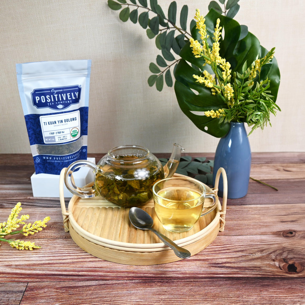 Loose Ti Kuan Yin leaves arranged for a relaxed tea ritual by Organic Positively Tea Company.