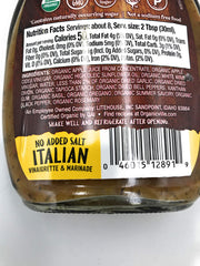 Pouring Organicville salt-free Italian dressing over a fresh salad.