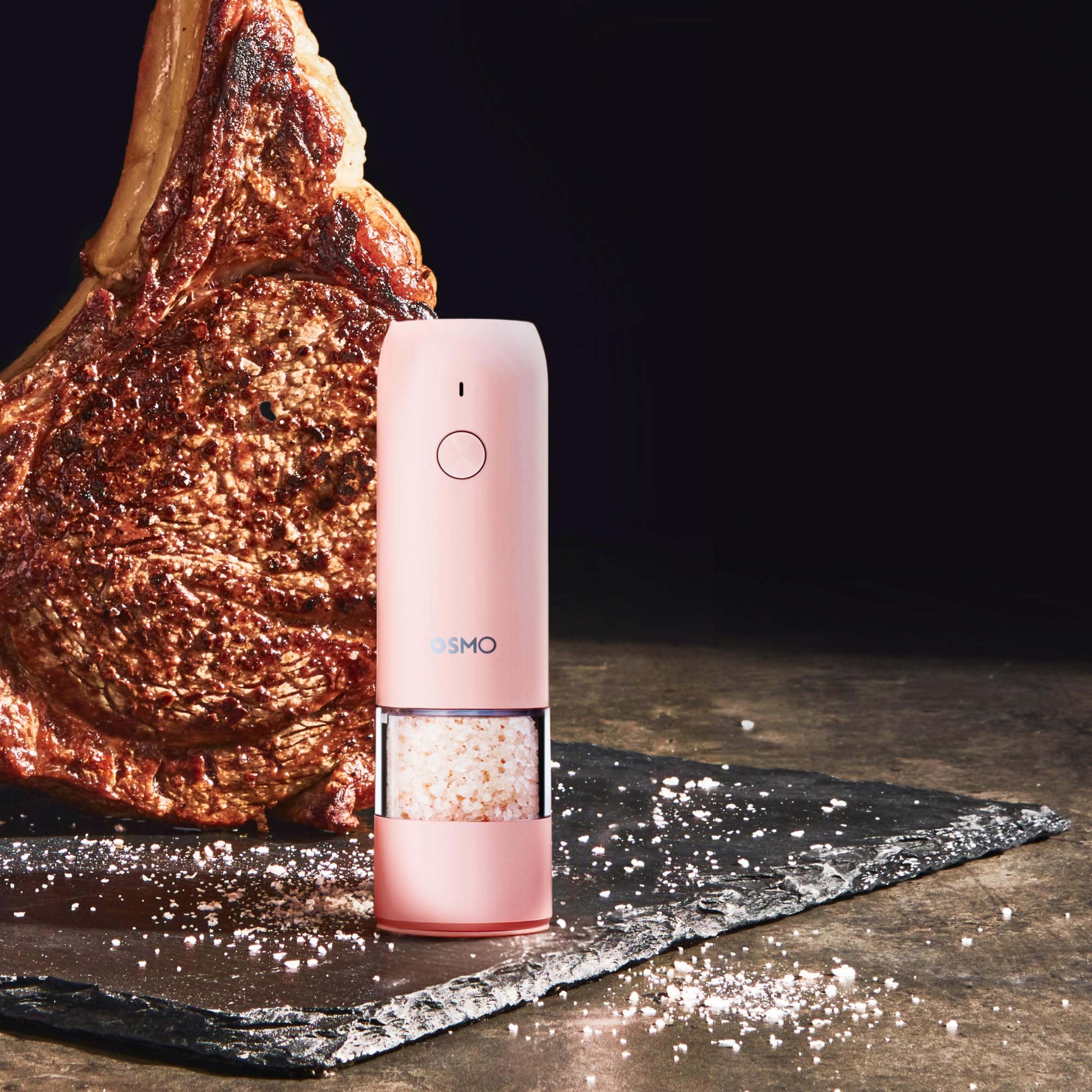 Osmo grinder on dining table seasoning dish showing stylish pink finish and convenience