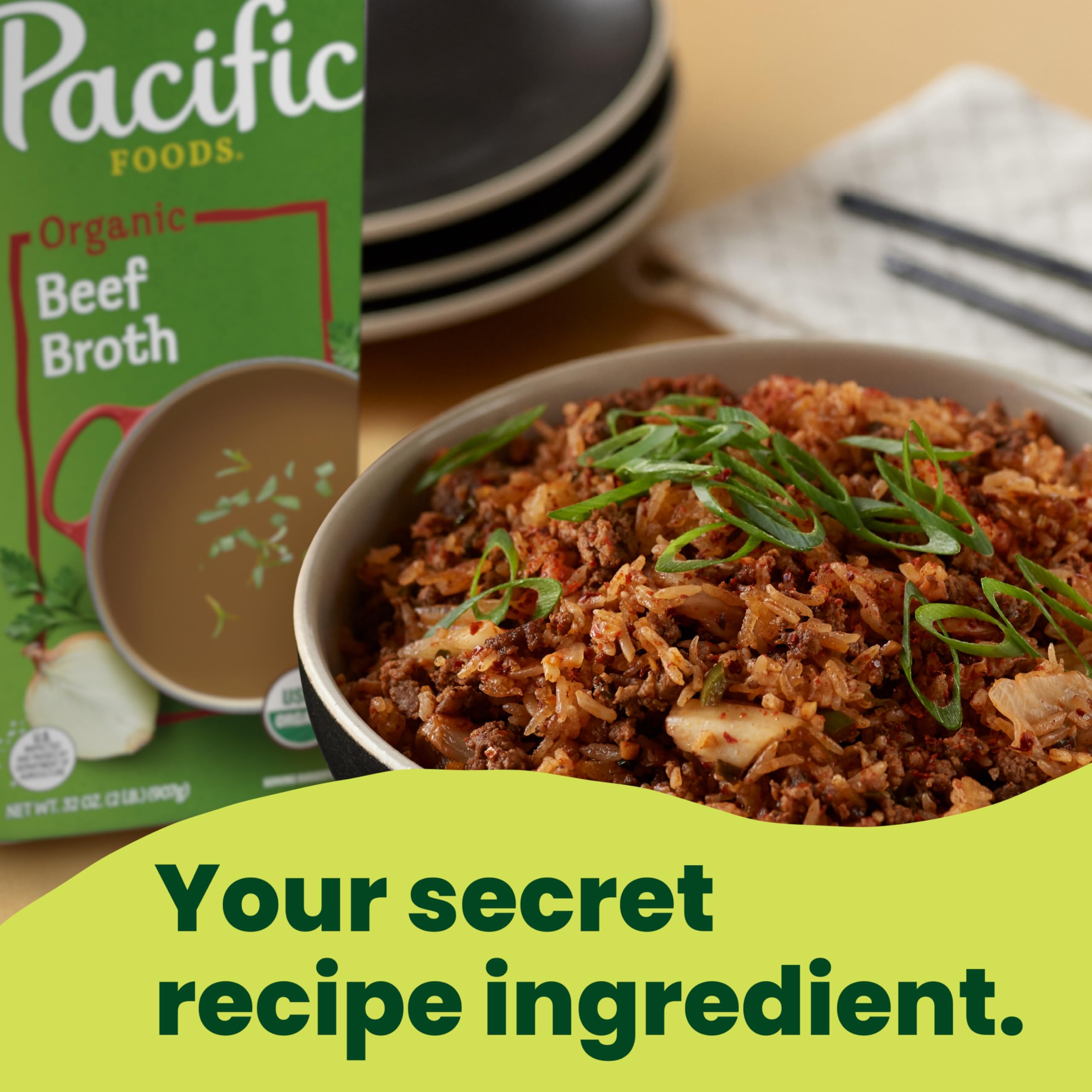 Pouring Pacific Foods Organic Beef Broth into a pot for flavor.