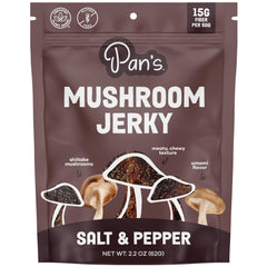 Pan's Mushroom Jerky salt pepper slices on board for a savory plant-based snack