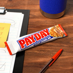 PAYDAY bar in office snack setting for quick satisfying energy.