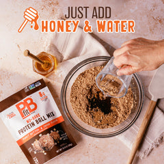 PBfit protein balls rolled from mix on a tray.