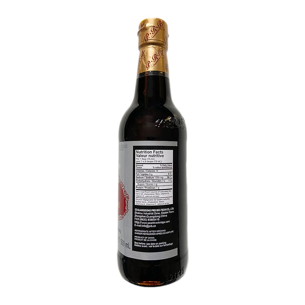 Pouring Pearl River Bridge dark soy sauce enhances depth in sauces.