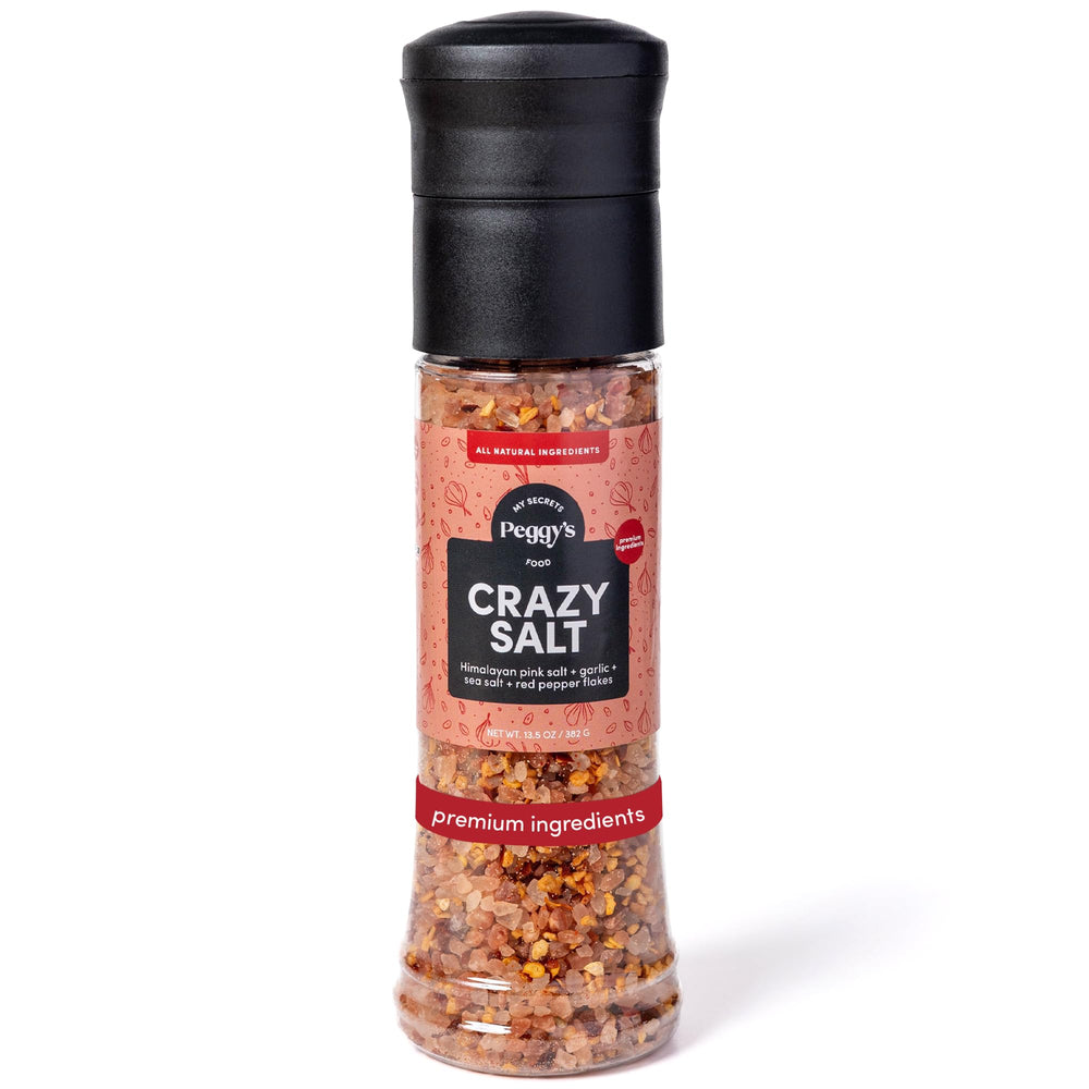 Peggy's Crazy Salt fine-grain bottle close-up showing bold flavor for grilling and finishing.