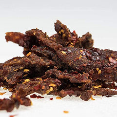 Pepper Joe’s jerky closeup shows pepper mash and glossy glaze