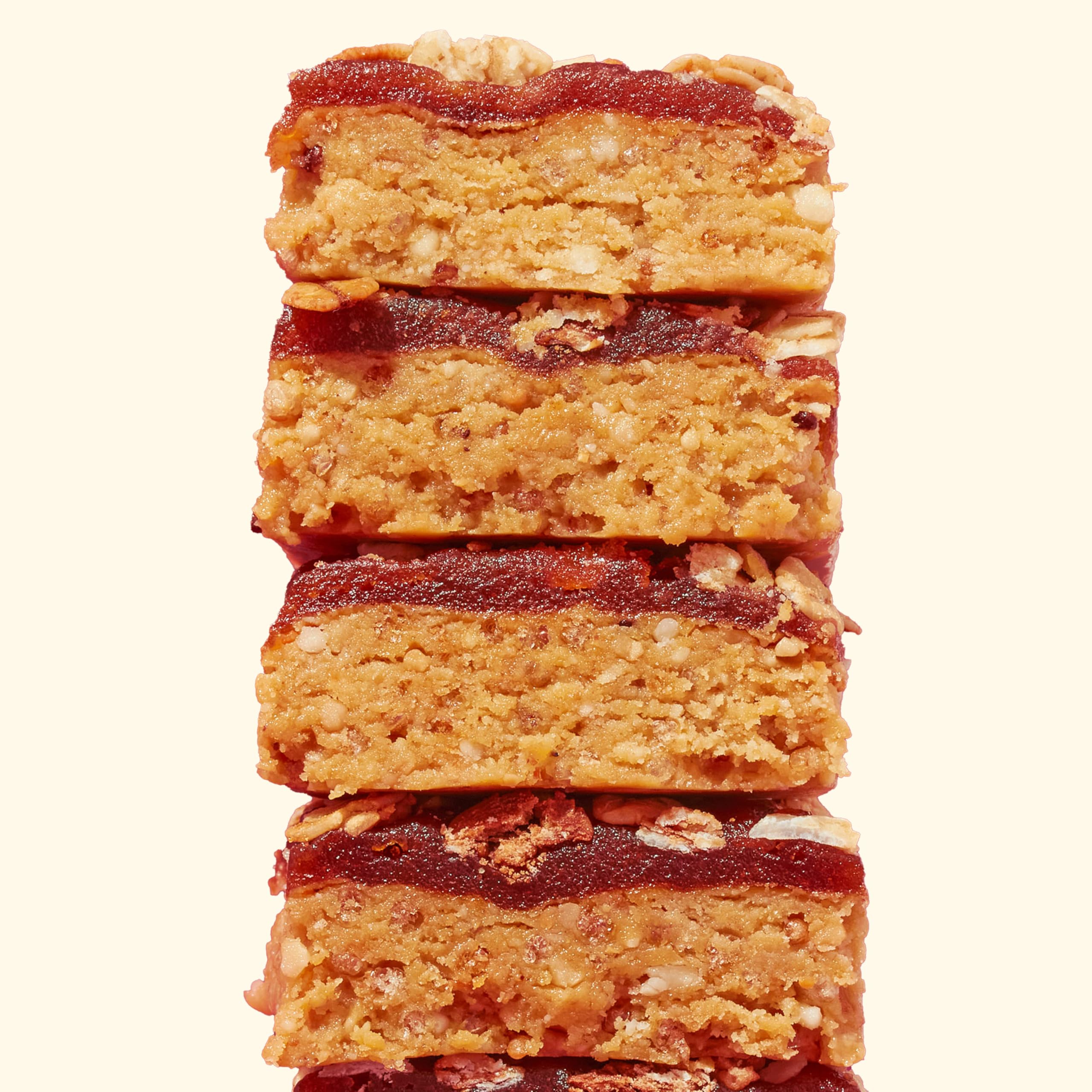 Perfect Bar Fruit Crisp Mixed Berry bar cross-section reveals quinoa crisps and honey sweetness.