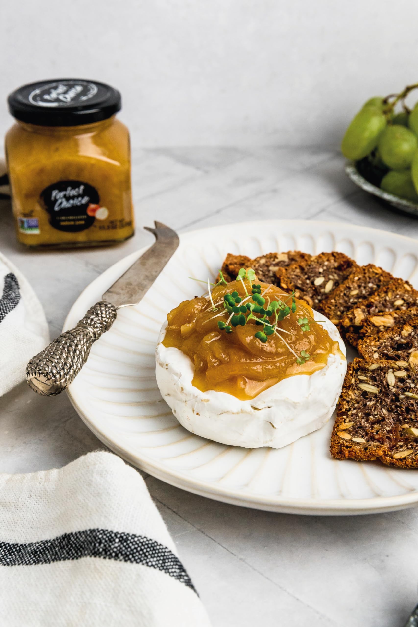 Perfect Choice Caramelized Onion jar beside cheese board, versatile snack.