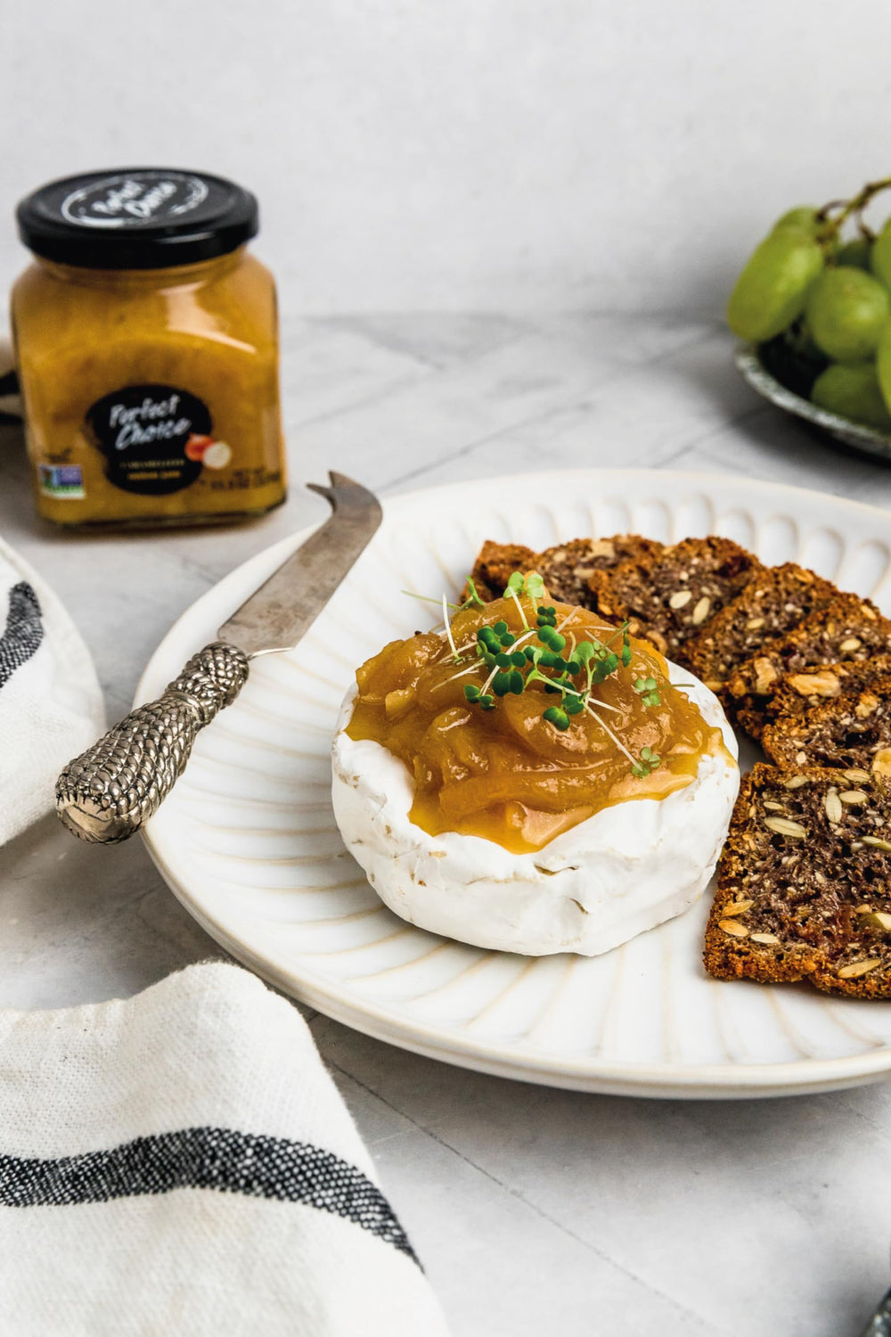 Perfect Choice Caramelized Onion jar beside cheese board, versatile snack.