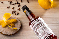 PEYCHAUD'S bitter pour angle shows controlled, balanced cocktail pouring.