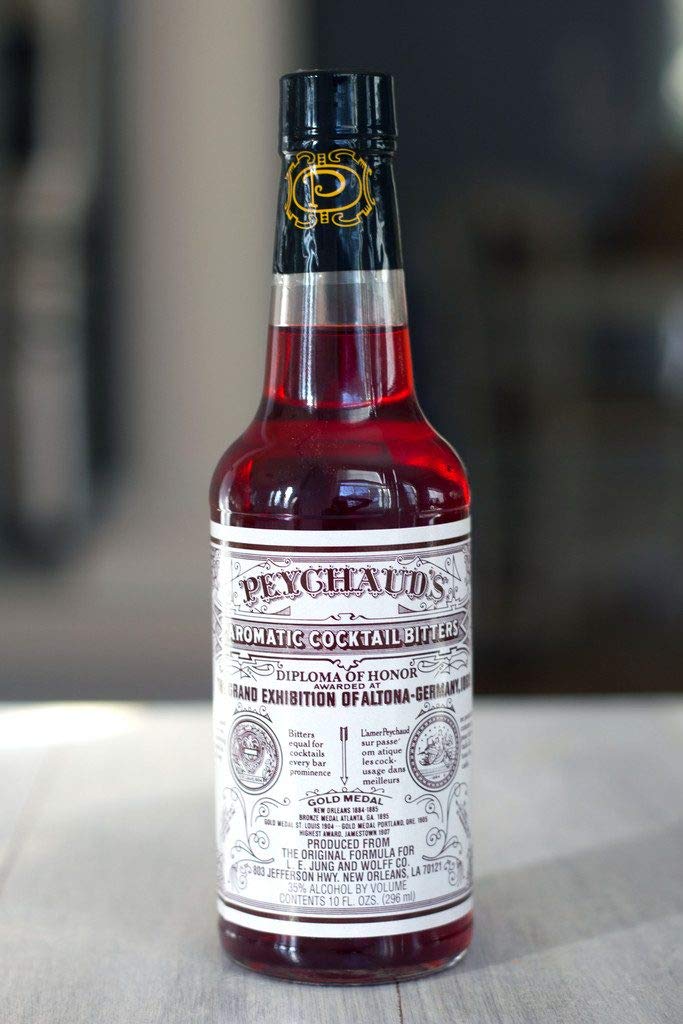 PEYCHAUD'S bottle label close-up aiding authentic aperitif recognition.