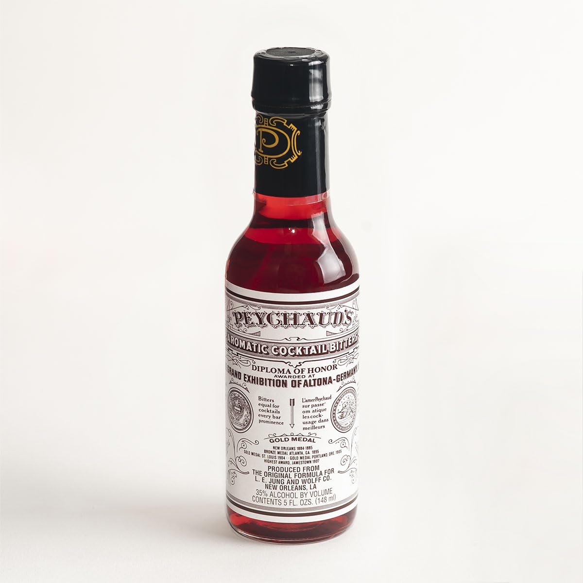 PEYCHAUD'S aromatic bitters bottle enhances flavor in classic cocktails
