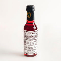 PEYCHAUD'S aromatic bitters bottle enhances flavor in classic cocktails