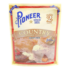 Pouring prepared gravy from Pioneer mix over biscuits and hash browns.