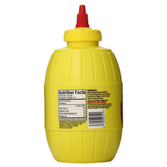 Plochman's Original Mild Yellow Mustard bottle pour, showcasing smooth texture for hot dogs.