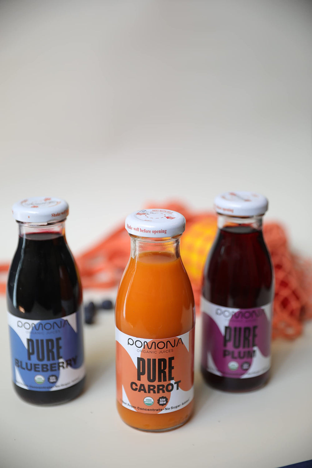 Front view of Pomona bottle revealing deep purple juice hue.
