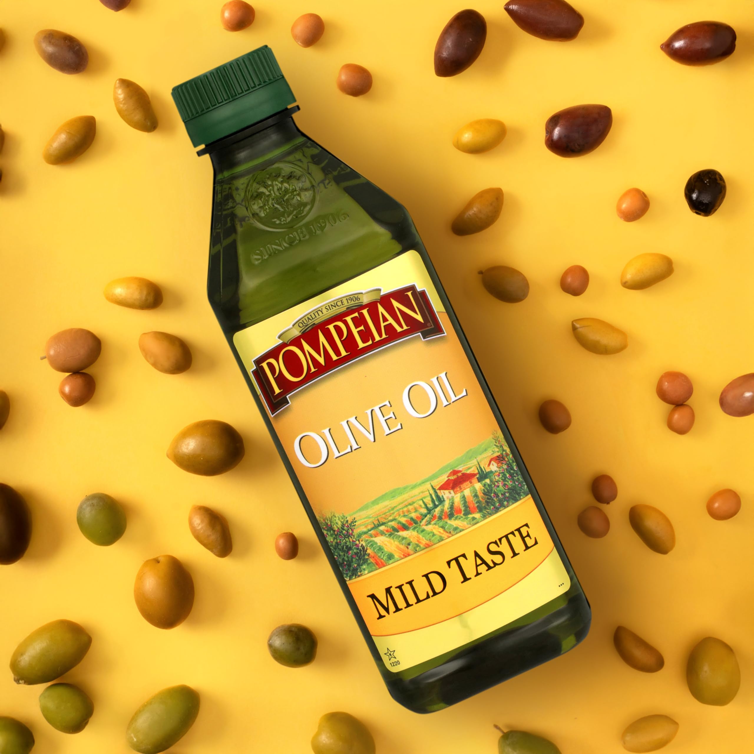 Pompeian Mild Taste Olive Oil drizzle over salad in a glass bowl.