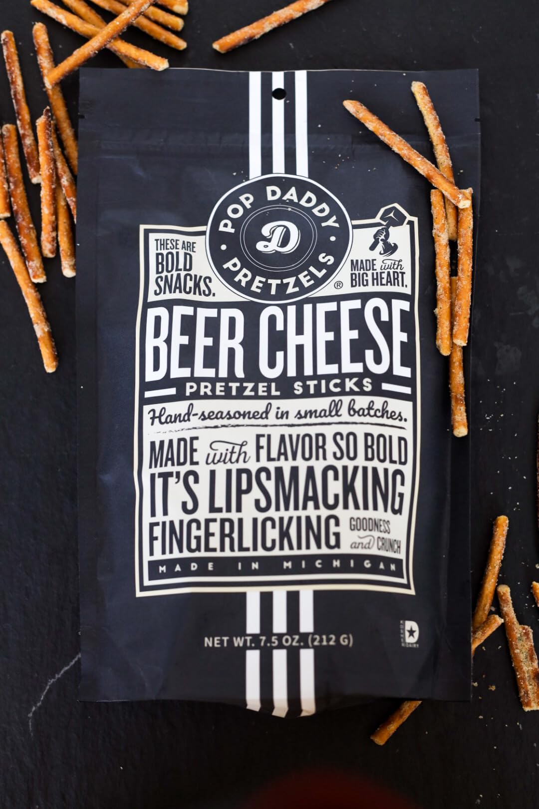 POP DADDY Beer Cheese pretzel sticks closeup with cheesy coating