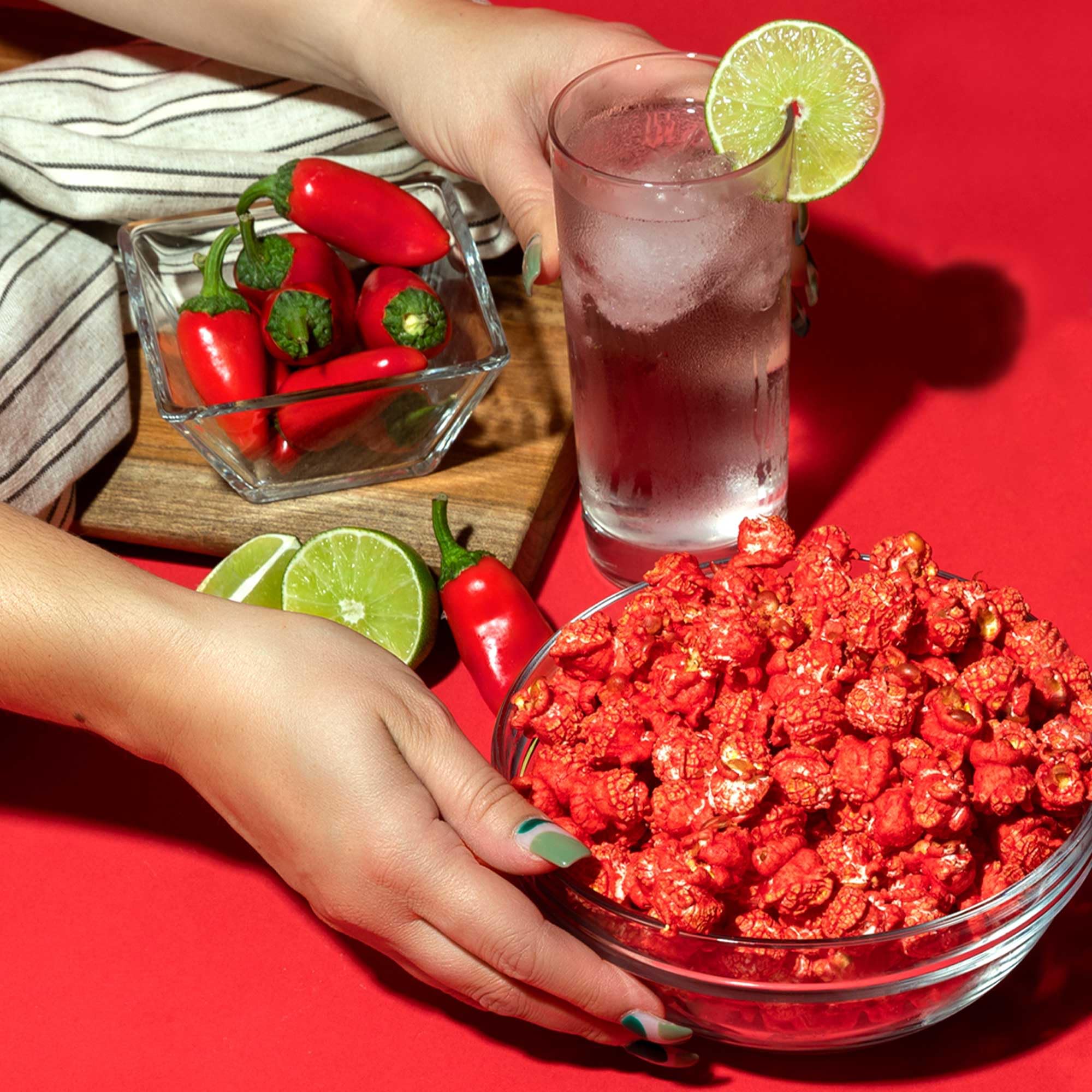 Popcornopolis Fuego Takis close-up heat splash emphasizes pepper heat and lime tang