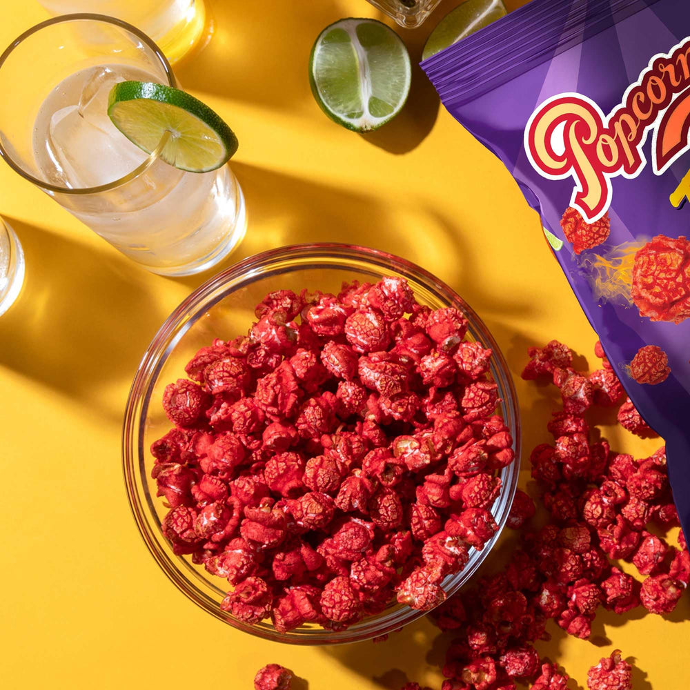 Popcornopolis Fuego Takis in a movie night scene demonstrates bold heat and lime aroma