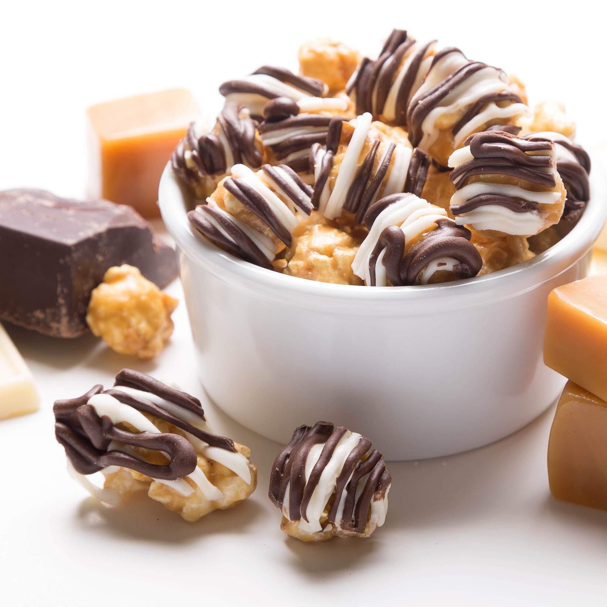 Popcornopolis Zebra striped caramel popcorn with confectionery chocolate drizzle, a premium snack.