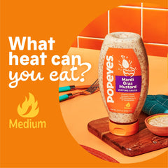Popeyes Mardi Gras Mustard drizzle on a dish for a jazzy finish.