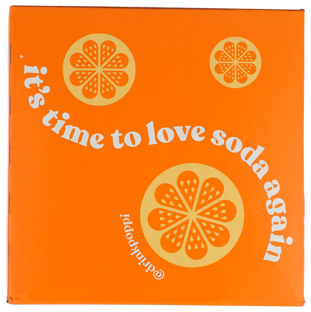 Glass with Poppi Orange soda showing sparkling bubbles and vibrant color.