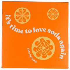 Glass with Poppi Orange soda showing sparkling bubbles and vibrant color.