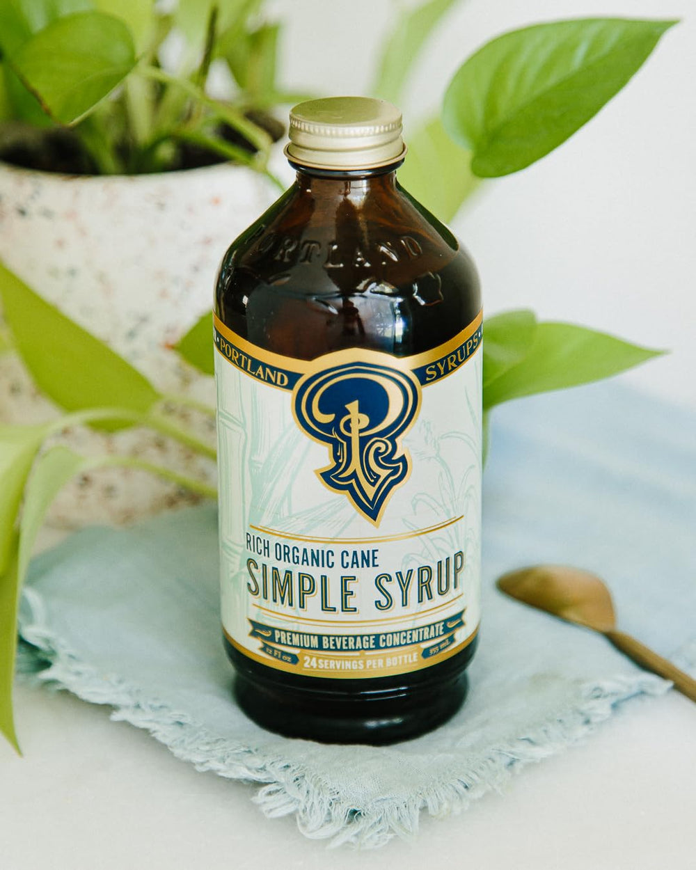Portland Syrups bottle in a cocktail glass illustrating versatile mixer