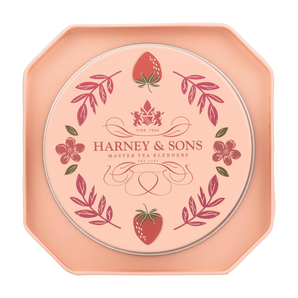 Pouring Harney & Sons Strawberry Milkshake tea into a cup for a velvety, dessert-inspired sip.