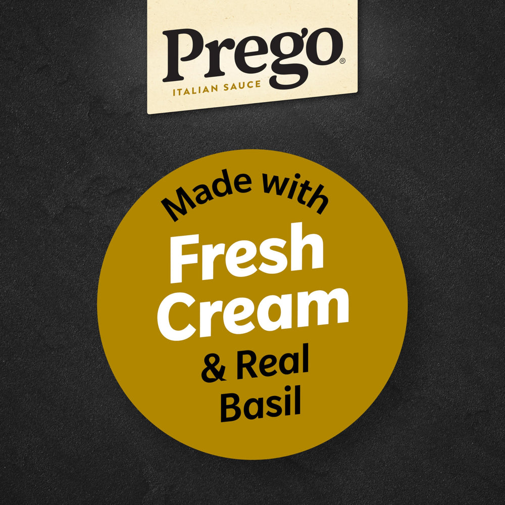 Prego Creamy Parmesan Pesto with spoon and pasta ready for dipping.
