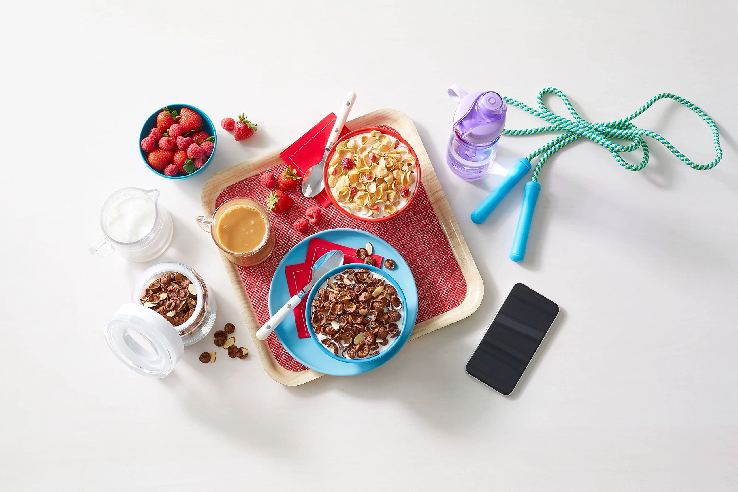 Pouring Premier Protein Chocolate Almond Cereal into a bowl with fruit.