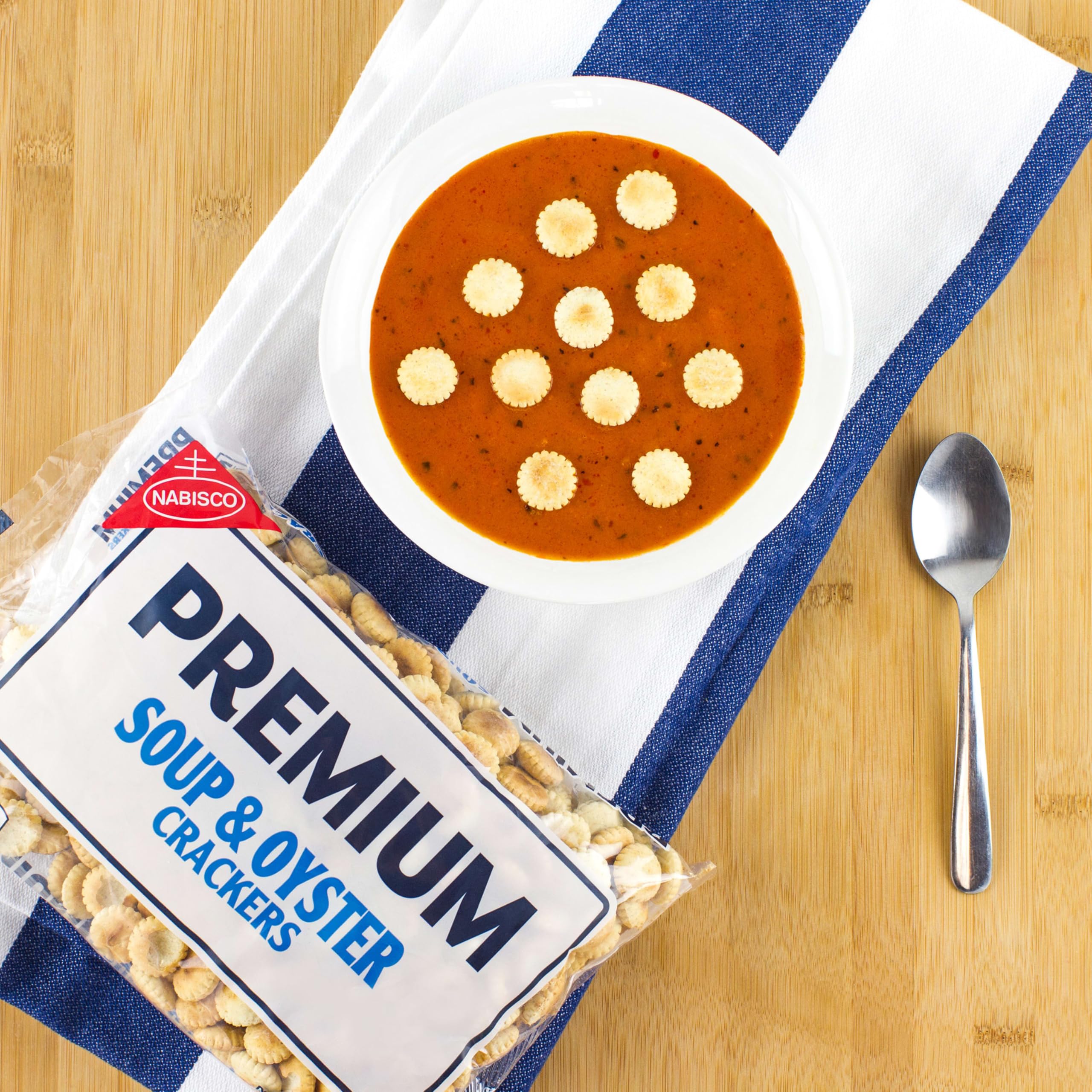 Premium Minis Original Saltine Crackers held in hand for on-the-go snacking.