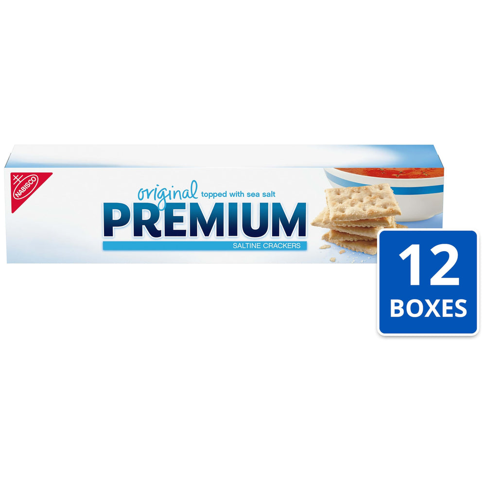 Premium Original Saltine Crackers dipping into soup for a comforting bite.