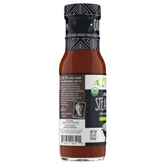 Primal Kitchen steak sauce glazed over a sizzling steak for smoky flavor.