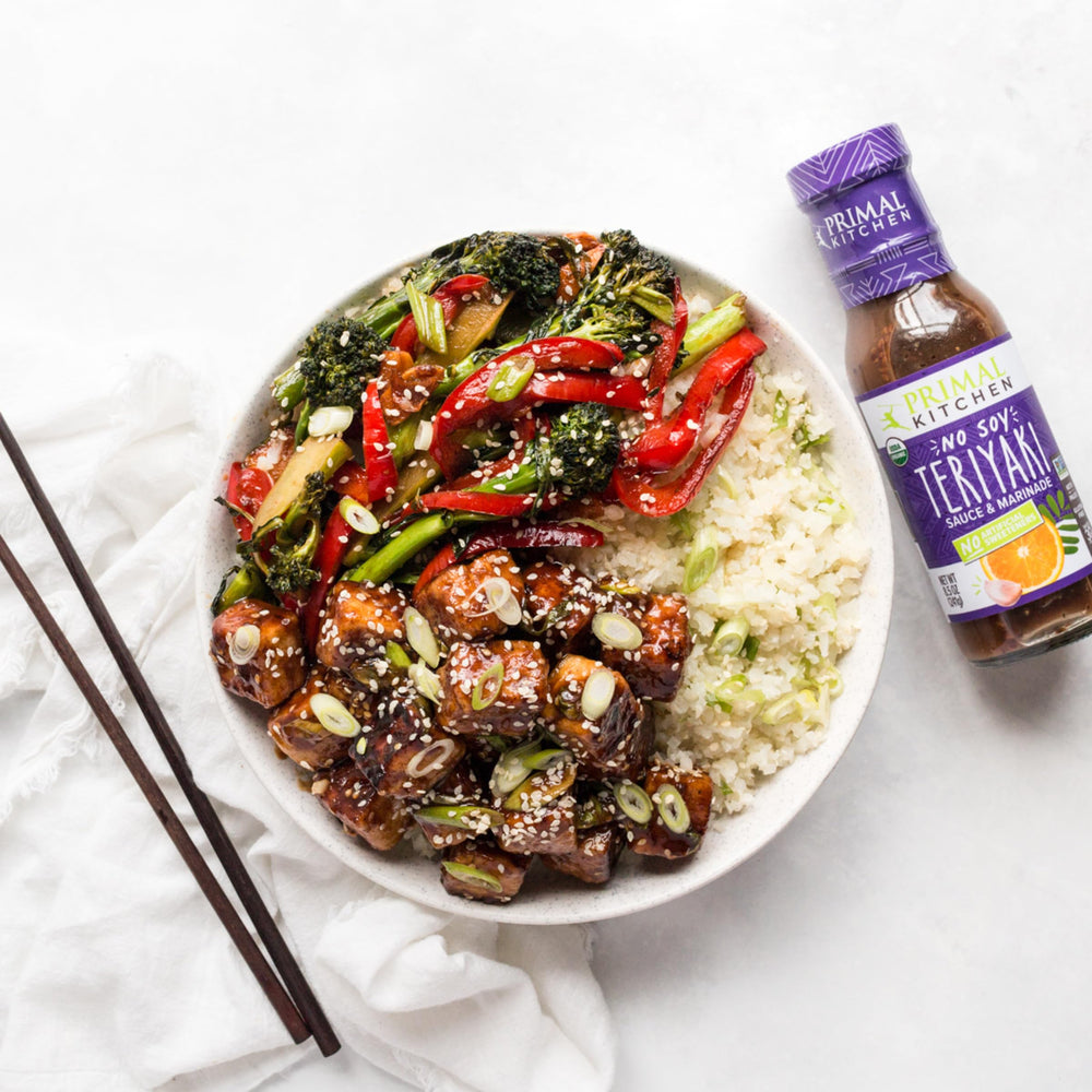 Primal Kitchen Teriyaki sauce bottle closeup shows rich, amber glaze.