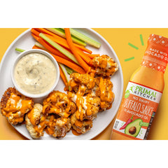 Primal Kitchen No Dairy Buffalo Sauce with cauliflower bites for spicy, dairy-free bite