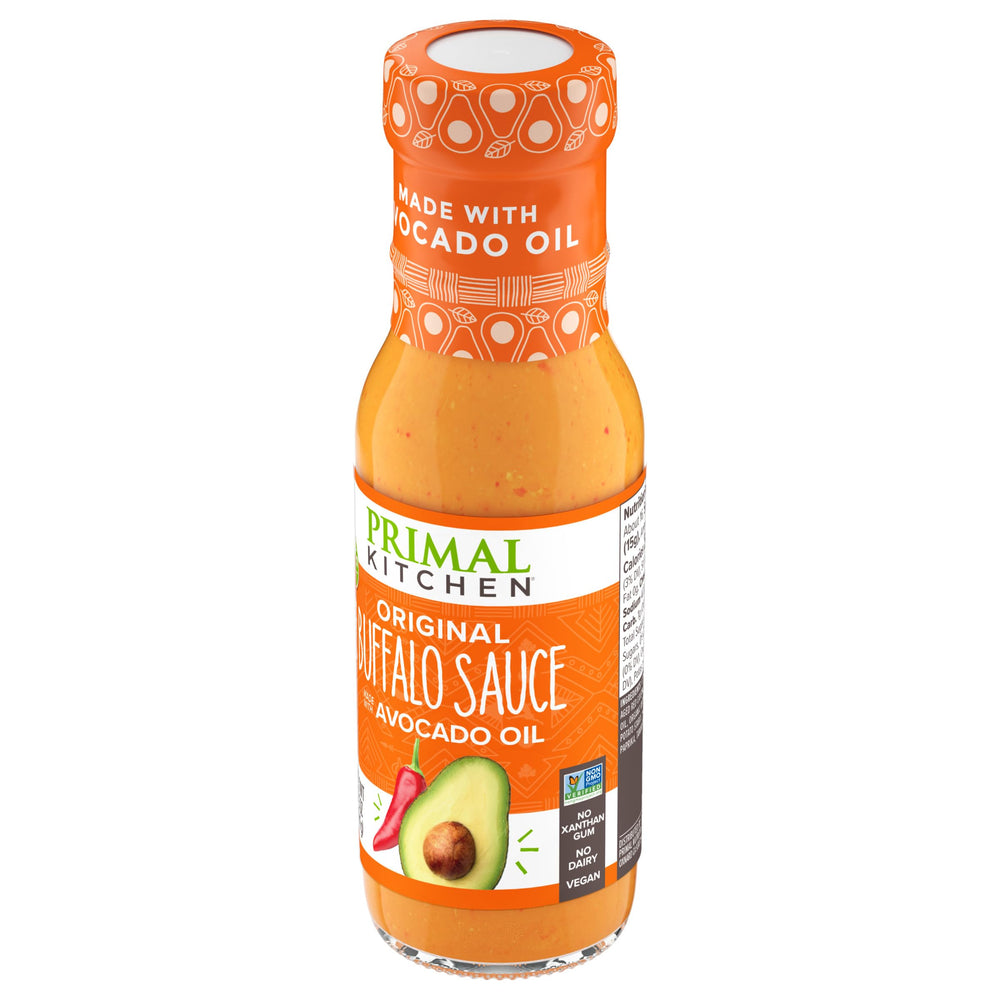 Primal Kitchen No Dairy Buffalo Sauce bottle with ladle ready to coat fries