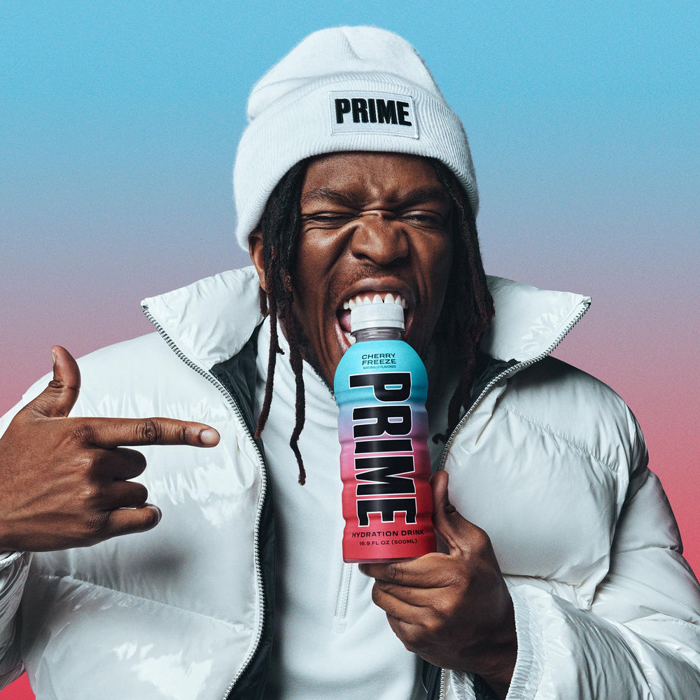 Prime Hydration Cherry Freeze ice cubes beside bottle suggest cool, thirst-quenching refreshment.
