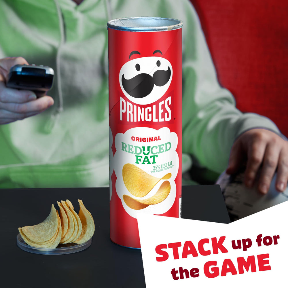 Pringles Reduced Fat can on desk, a quick office snack during breaks.