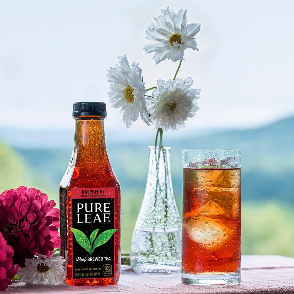 Serving Pure Leaf Raspberry Iced Tea in a glass with ice for refreshing enjoyment