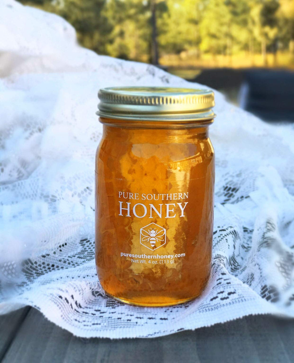 Pure Southern Honey hand filled jar close-up demonstrates artisanal care.