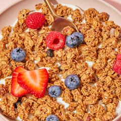 Purely Elizabeth Berry Crisp Granola on milk, ideal for fast breakfast.
