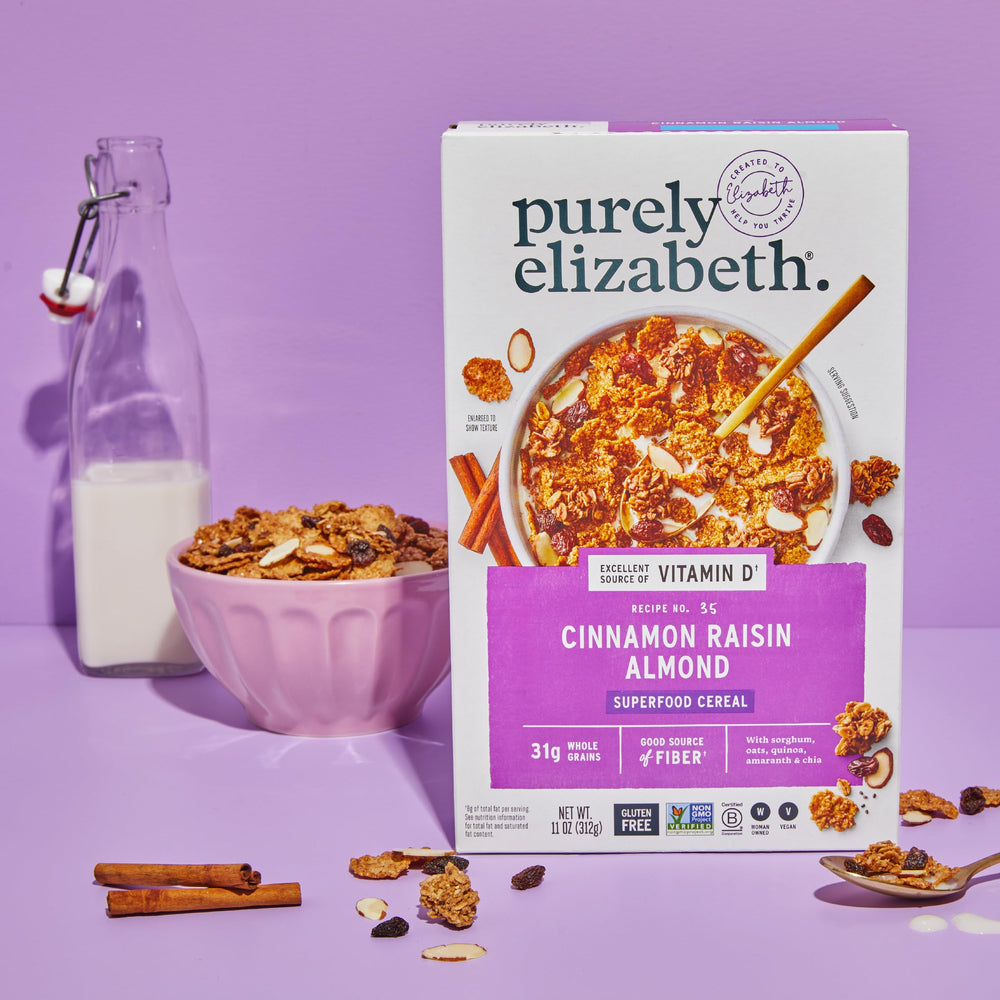 Pouring milk over Purely Elizabeth Cinnamon Raisin Almond cereal for quick nourishment.