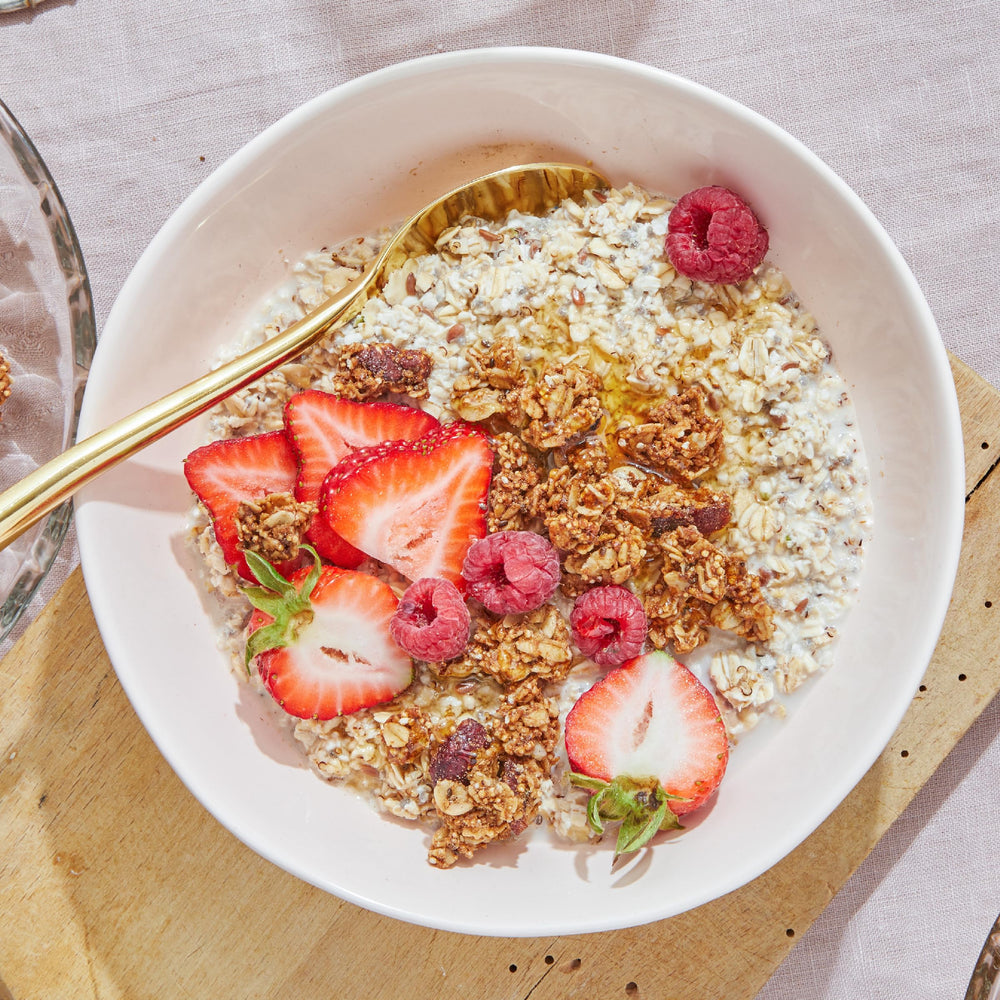 Purely Elizabeth cranberry pecan granola snack hero for travel or desk.