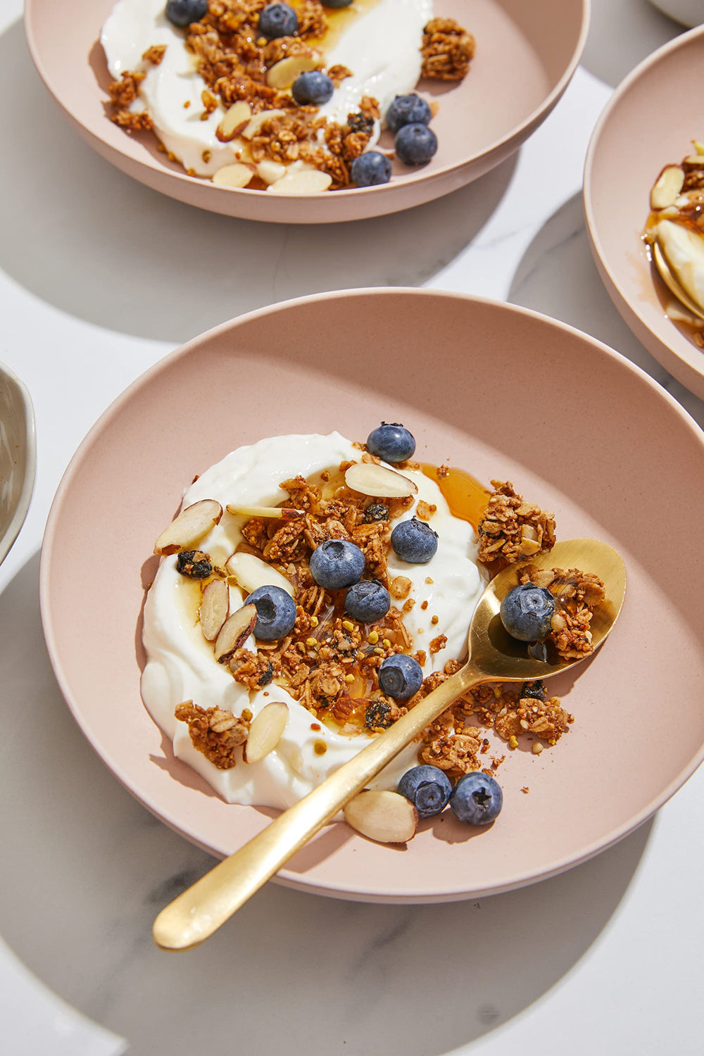 Purely Elizabeth granola served with yogurt or milk for a versatile breakfast
