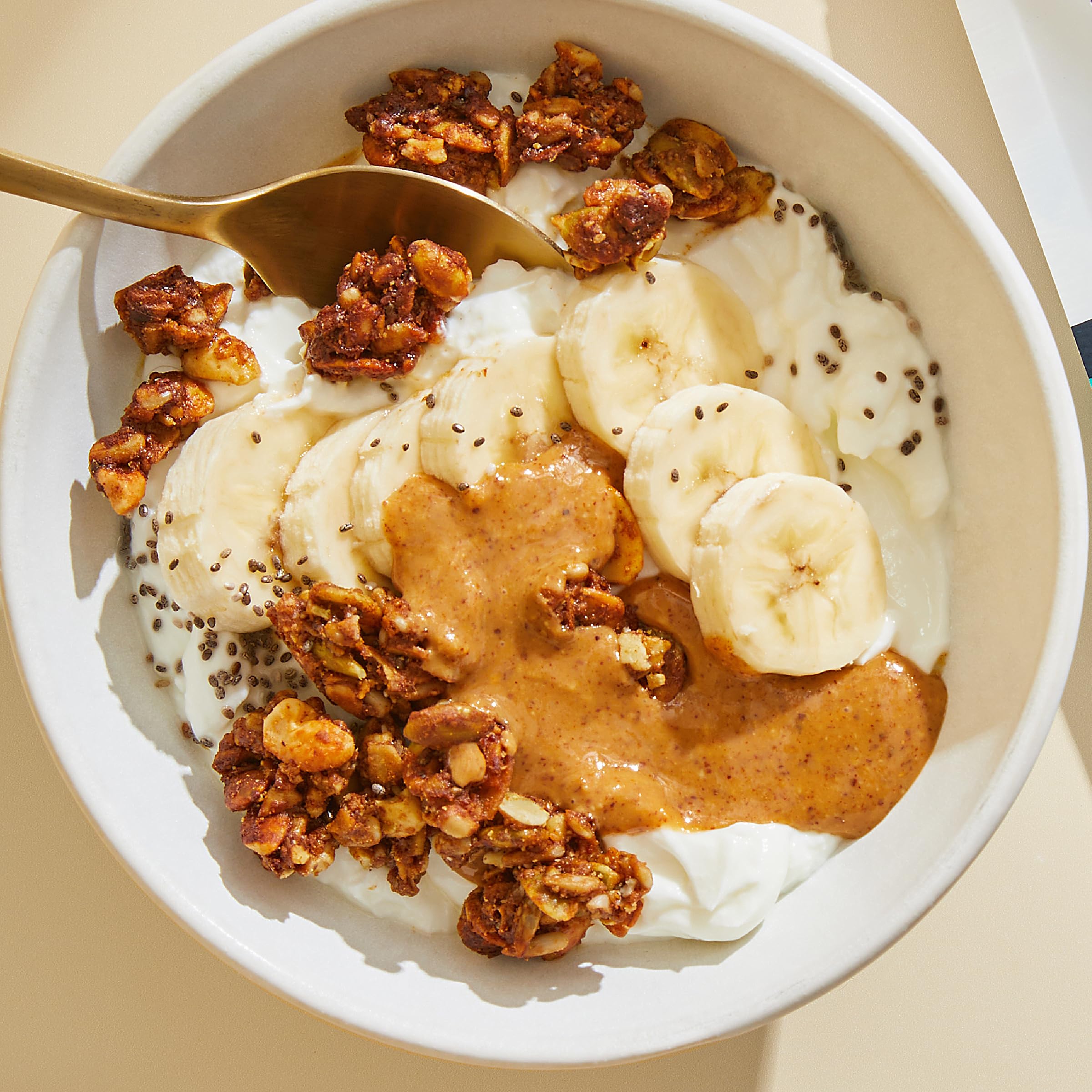 Purely Elizabeth granola topping on yogurt for a versatile snack