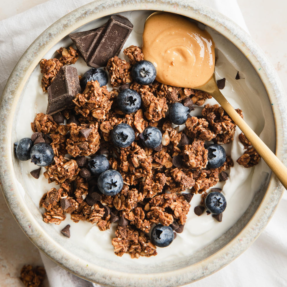 Purely Elizabeth probiotics granola served with yogurt and fruit for a balanced snack.