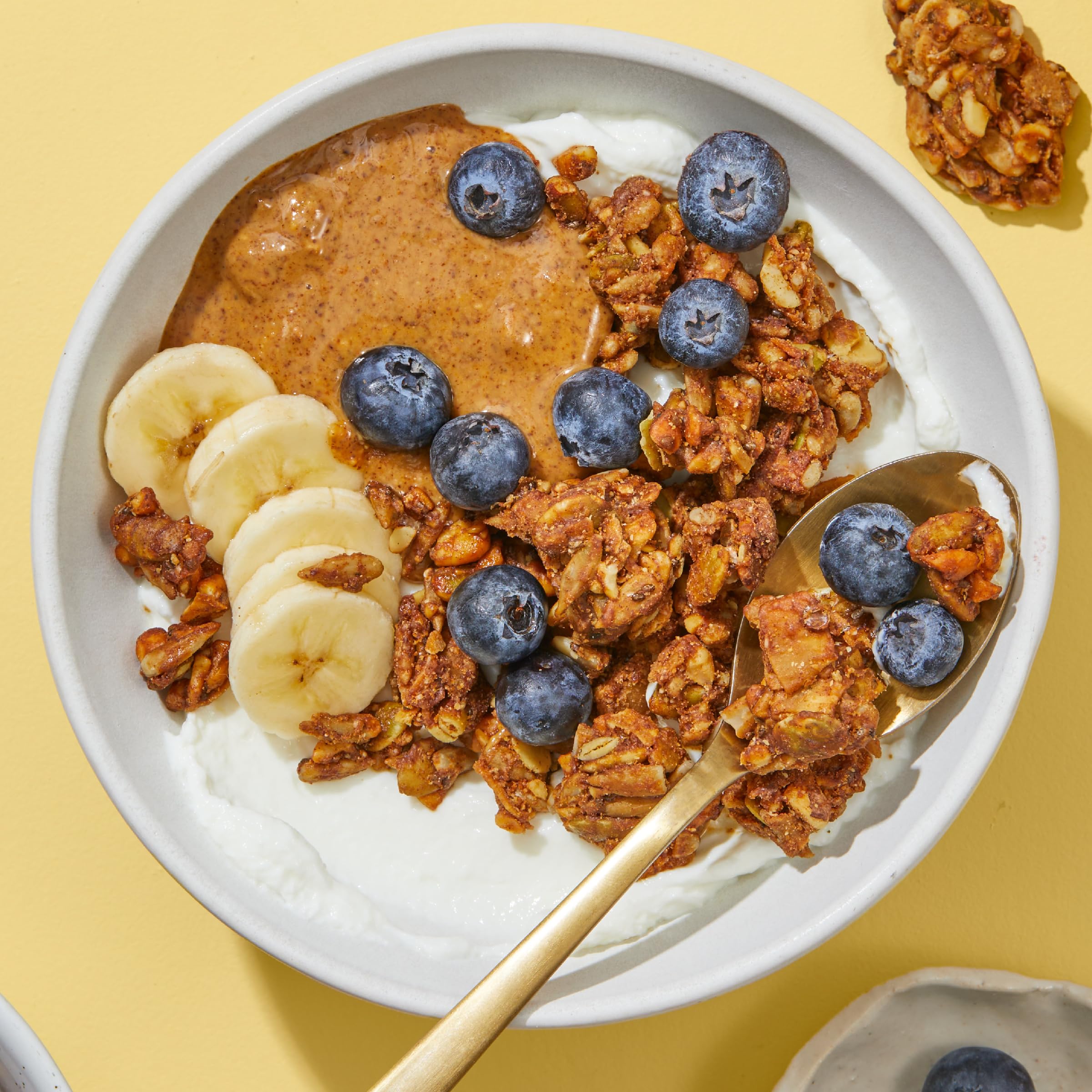 Purely Elizabeth Banana Nut Butter Granola serving ideas with milk and fruit.