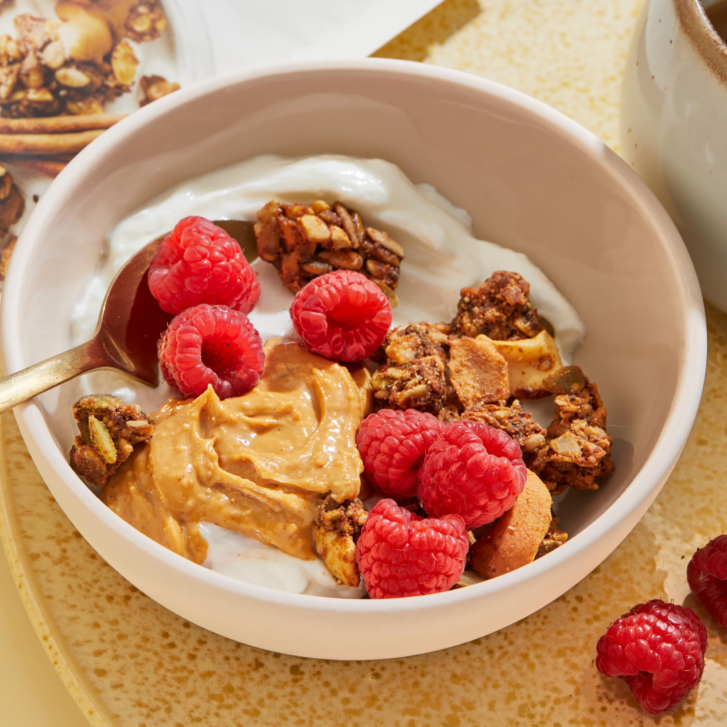 Purely Elizabeth Granola served with milk or yogurt for a versatile breakfast.